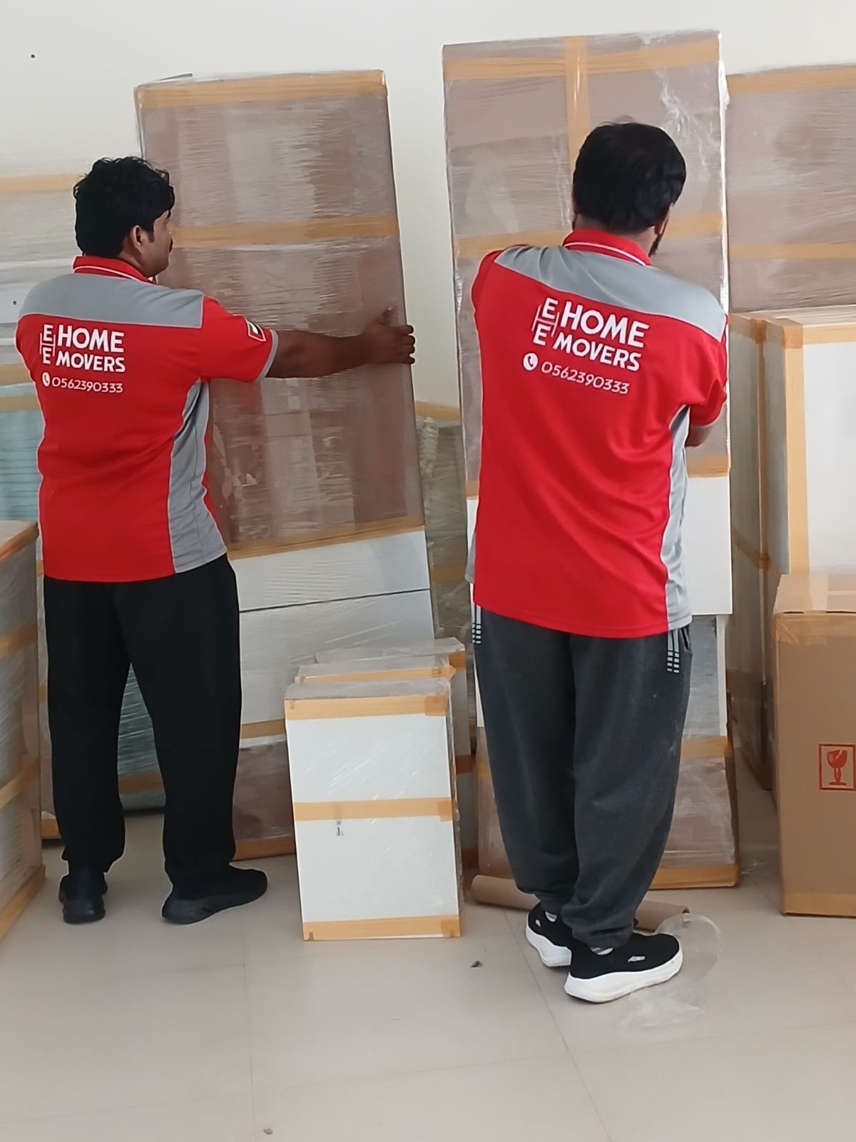 E-Home Movers team loading packed items into moving truck in Dubai